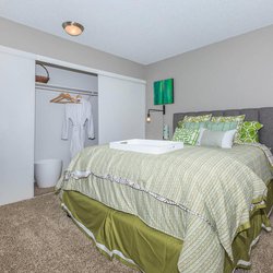 Carpeted furnished bedroom with oversized closets at The Oslo, located in Northglenn, CO