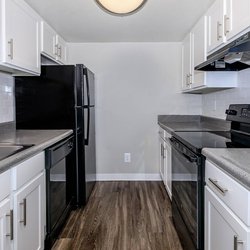 Kitchen with all-electric stainless steel appliances and white cabinets at The Oslo, located in Northglenn, CO